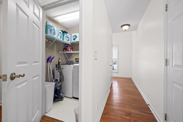 washroom with washer and dryer and hardwood / wood-style flooring