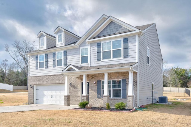 craftsman inspired home with a front lawn, central AC unit, and a garage