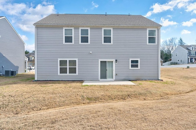 rear view of property with a patio area, a yard, and central AC unit