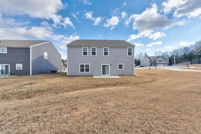 back of property featuring a patio, central AC, and a lawn