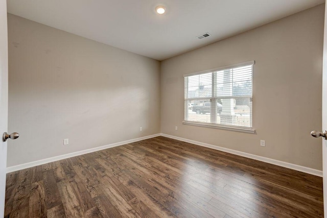 spare room with dark hardwood / wood-style floors