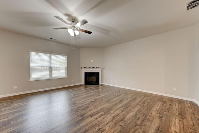 unfurnished living room with ceiling fan and dark hardwood / wood-style floors