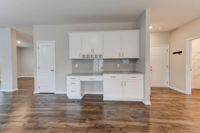 kitchen with decorative backsplash, white cabinetry, and dark wood-type flooring