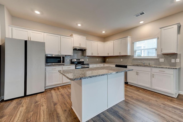 kitchen featuring light stone countertops, white cabinets, and appliances with stainless steel finishes