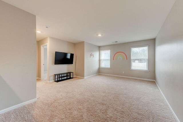 unfurnished living room featuring light colored carpet