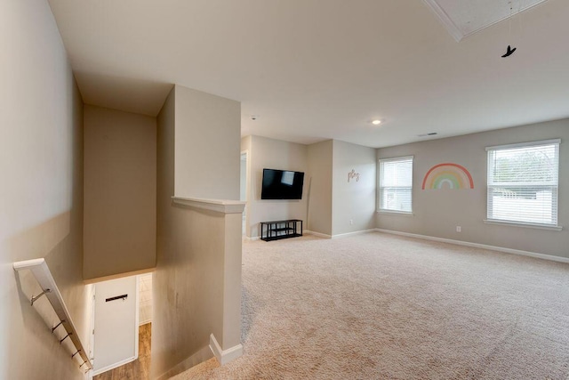 unfurnished living room with light colored carpet