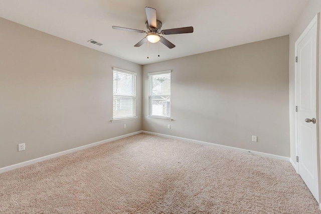 carpeted spare room with ceiling fan