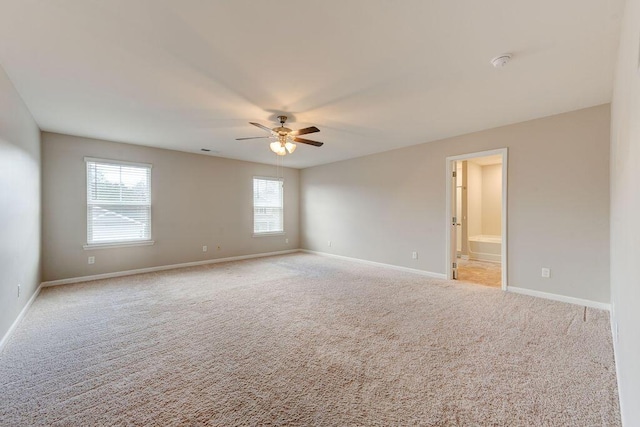 empty room featuring ceiling fan and light colored carpet