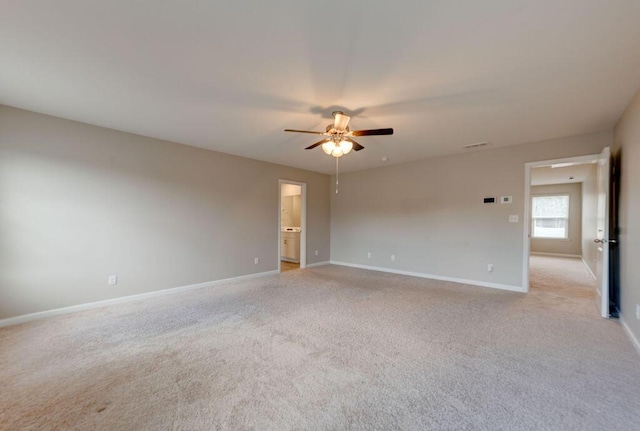 spare room featuring light carpet and ceiling fan