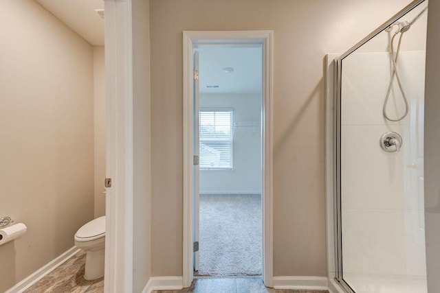 bathroom with an enclosed shower and toilet