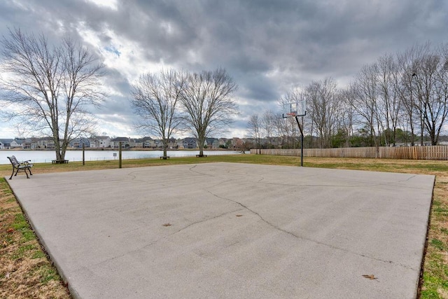 view of sport court with a water view