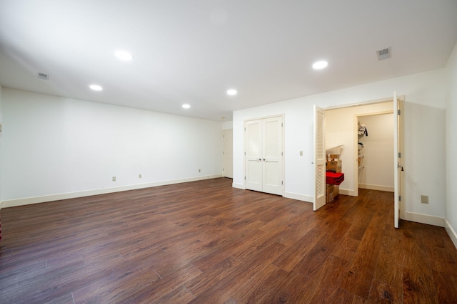 unfurnished bedroom with dark hardwood / wood-style flooring