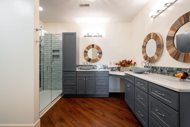 bathroom featuring an enclosed shower, vanity, and hardwood / wood-style floors