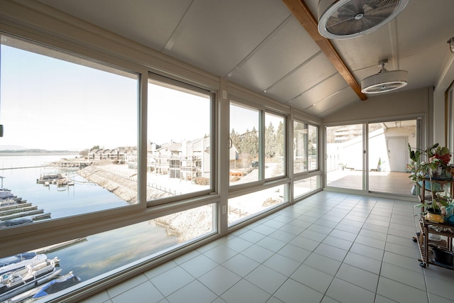 unfurnished sunroom with lofted ceiling, a water view, and a healthy amount of sunlight