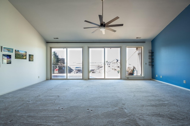 unfurnished living room with ceiling fan, carpet floors, and vaulted ceiling