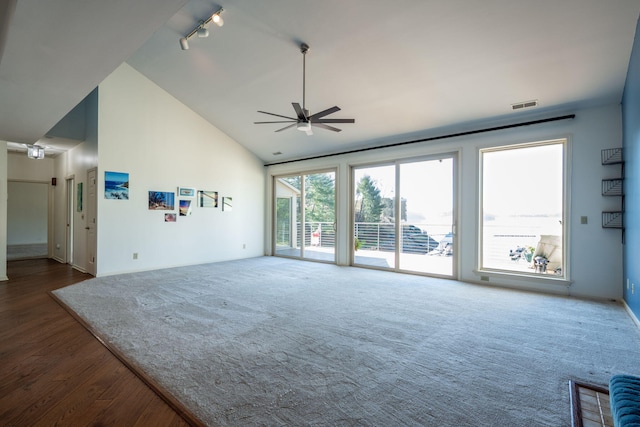 unfurnished living room featuring ceiling fan, track lighting, and high vaulted ceiling