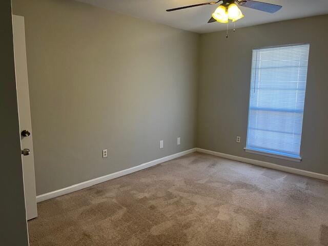 empty room featuring light carpet and ceiling fan