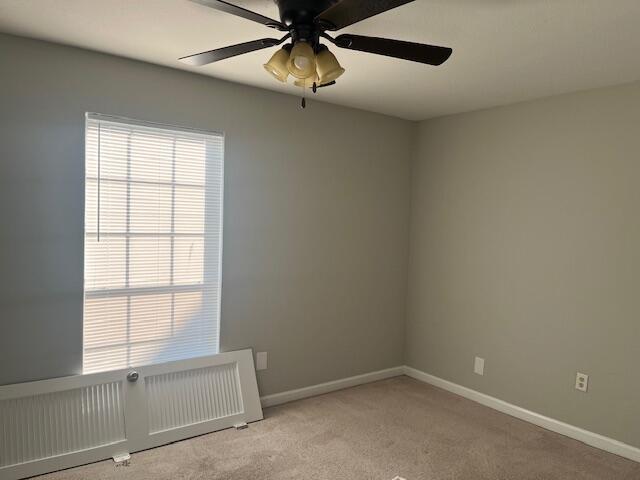 carpeted empty room with ceiling fan