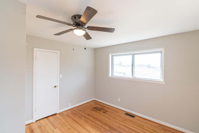 empty room featuring ceiling fan and light hardwood / wood-style flooring