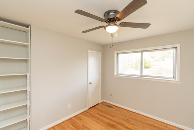 unfurnished bedroom featuring a closet, ceiling fan, and light wood-type flooring