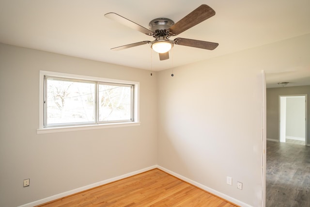 spare room featuring hardwood / wood-style flooring and ceiling fan