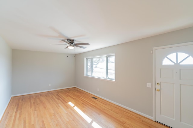 foyer entrance with ceiling fan and light wood-type flooring