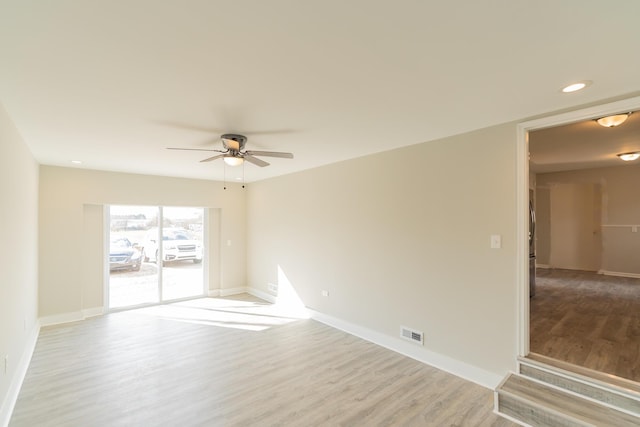 spare room with ceiling fan and light hardwood / wood-style floors