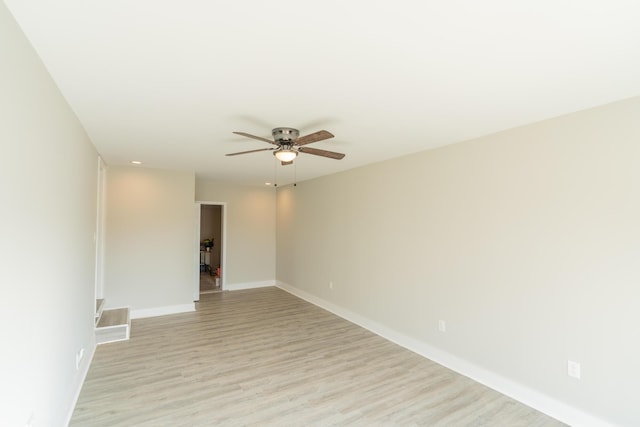 empty room with light wood-type flooring and ceiling fan