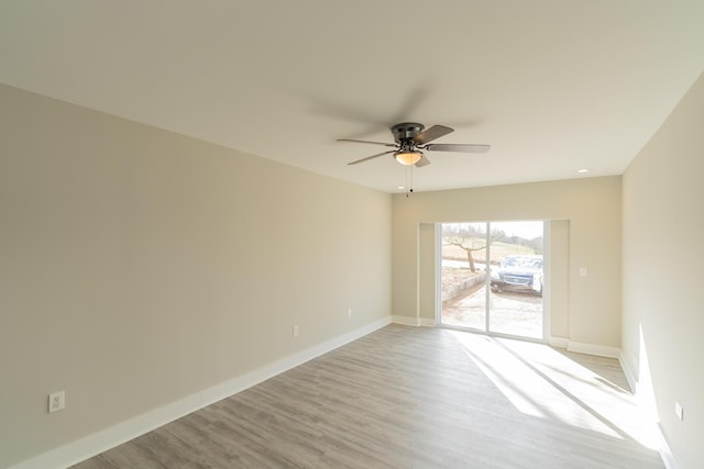 spare room featuring light wood-type flooring and ceiling fan