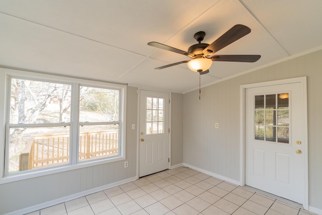 doorway to outside with light tile patterned floors, crown molding, vaulted ceiling, and ceiling fan