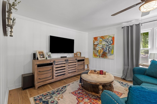 living room with light hardwood / wood-style floors and crown molding