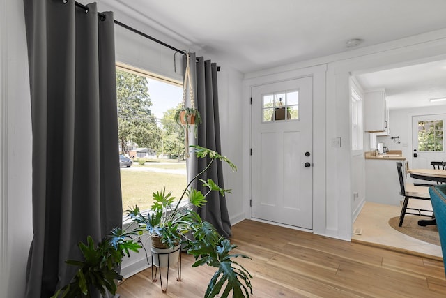 foyer entrance with plenty of natural light and light wood-type flooring