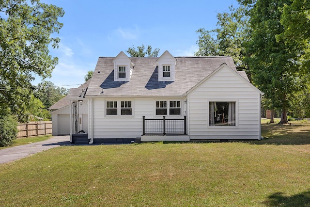 back of house with a garage and a lawn