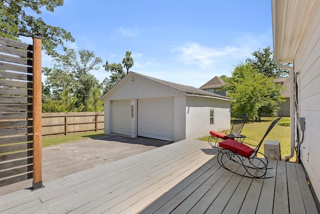 wooden deck featuring a yard, an outbuilding, and a garage