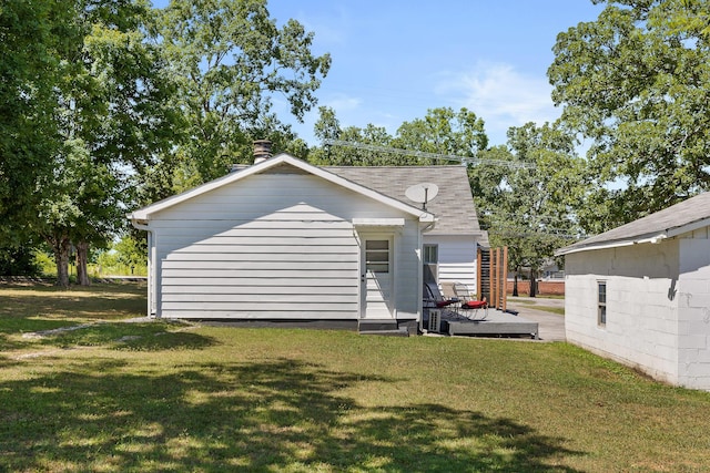 rear view of property with a yard