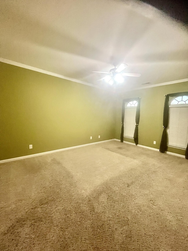 carpeted empty room featuring ceiling fan and ornamental molding