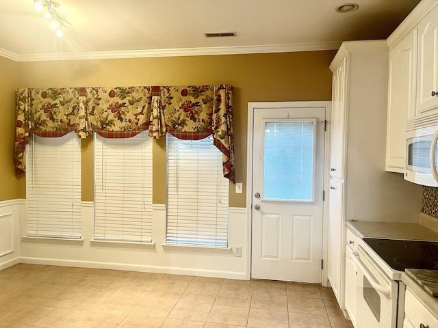 doorway to outside featuring light tile patterned flooring and crown molding