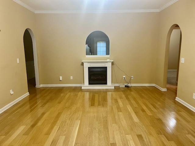 unfurnished living room with light hardwood / wood-style flooring and ornamental molding