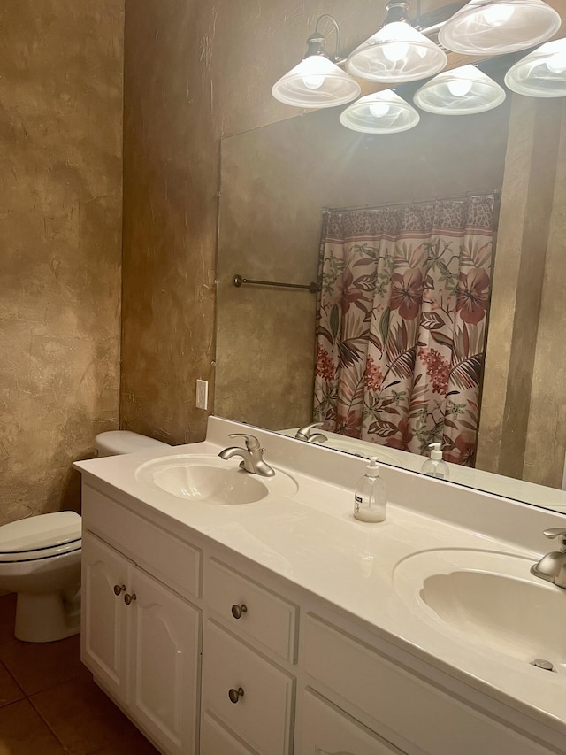 bathroom with tile patterned flooring, vanity, and toilet