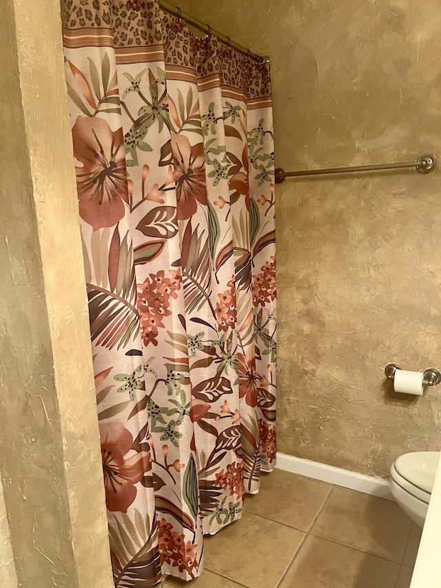 bathroom featuring tile patterned floors and toilet