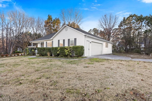 view of side of property featuring a garage and a yard