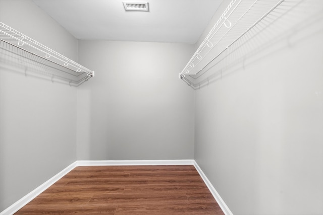 spacious closet with hardwood / wood-style floors