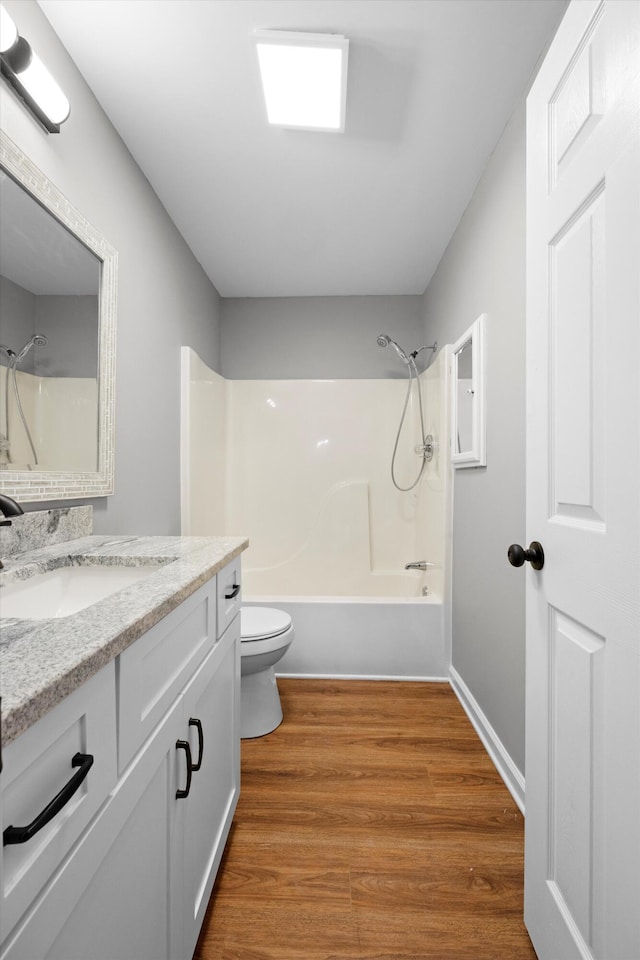 full bathroom with shower / bathing tub combination, hardwood / wood-style floors, vanity, and toilet