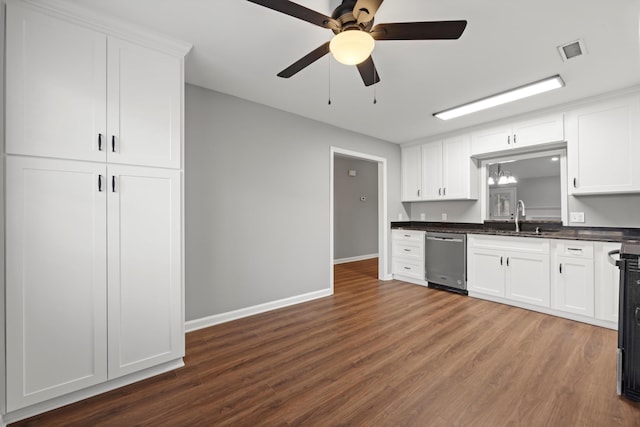 kitchen with sink, dark hardwood / wood-style flooring, stainless steel dishwasher, white cabinets, and ceiling fan with notable chandelier