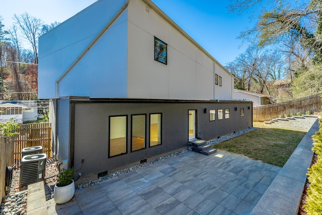 back of property with cooling unit and a patio area