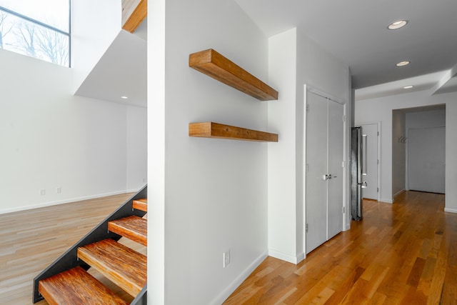 hallway with hardwood / wood-style flooring