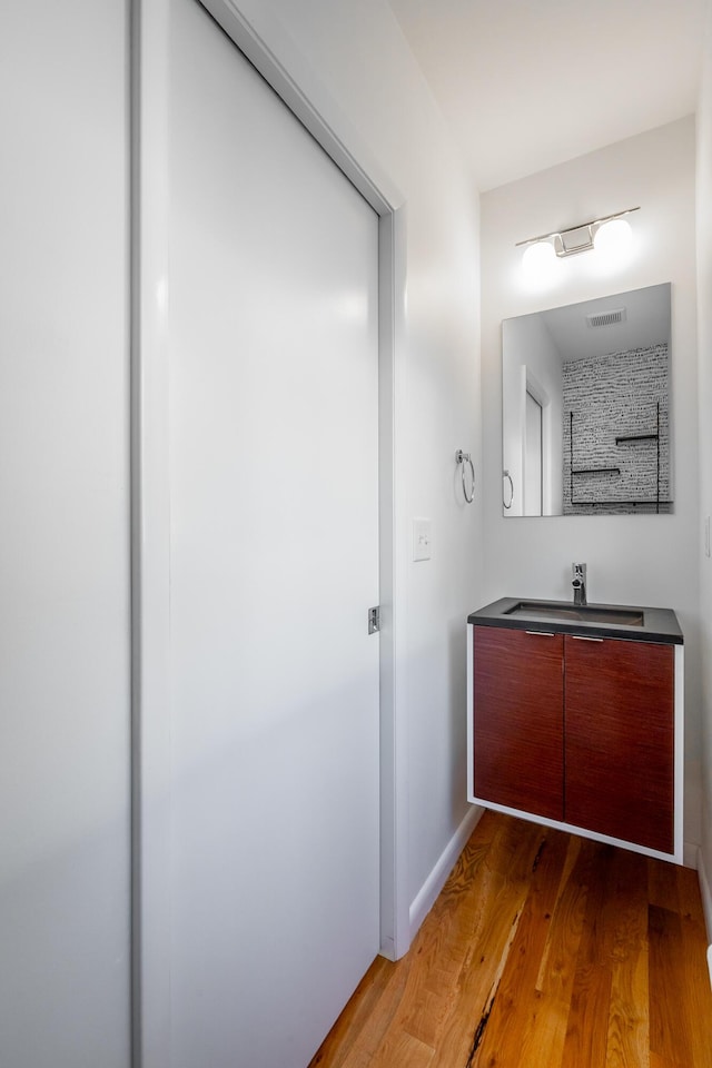 bathroom with vanity and hardwood / wood-style flooring