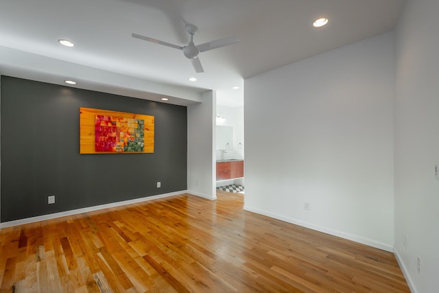 spare room featuring hardwood / wood-style floors and ceiling fan