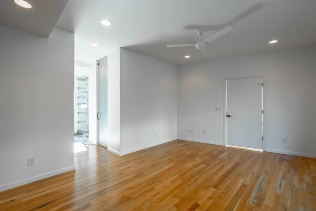 empty room with ceiling fan and light wood-type flooring