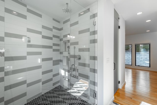 bathroom with hardwood / wood-style flooring and walk in shower